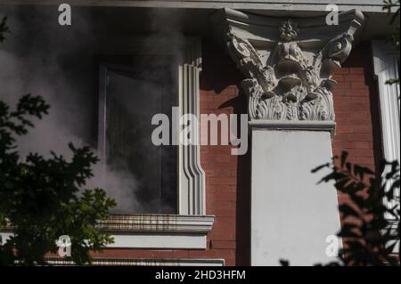 South Africa's national parliament smouldering after a fire broke out in the early hours of 2 January 2022 in central Cape Town Stock Photo