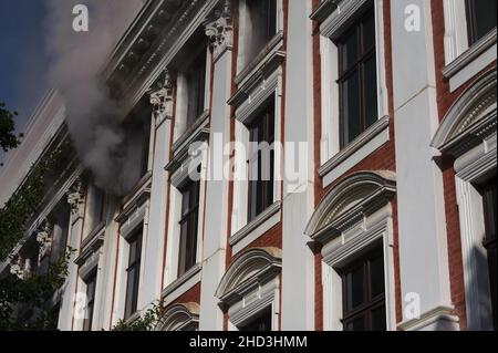 South Africa's national parliament smouldering after a fire broke out in the early hours of 2 January 2022 in central Cape Town Stock Photo