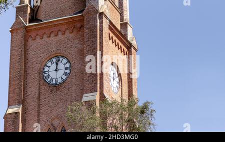 Twelve o'clock on clock bricked tower of Fredrikstad Cathedral in Norway Stock Photo