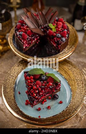 Creamy chocolate cake with raspberry and pomegranate, a delicious treat Stock Photo