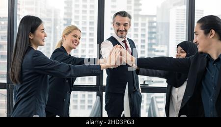 Teamwork successful business concept, leaders and office staff join hand together in succeed as team of small company in meeting room with happy smile Stock Photo