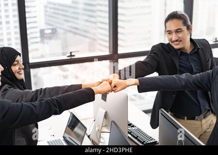 Teamwork successful business concept, office staff join hand together in succeed as team of small office in meeting room with happy smile and modern c Stock Photo