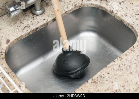 Closeup of the plunger in the kitchen sink. Stock Photo