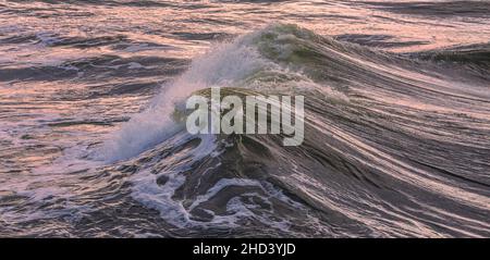 Wave breaking in the Baltic sea, evening light, background image of sea wave Stock Photo