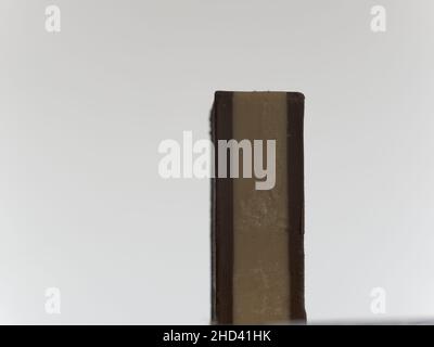 A close-up picture of a delicious chocolate chip cookie with green plant on a white background Stock Photo