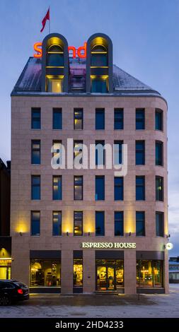 Turku, Finland - December 24, 2021: Vertical Night View of Scandic Hotel Buidling Front, Scandic is a Swedish Hotel Chain Operating in the Nordic coun Stock Photo