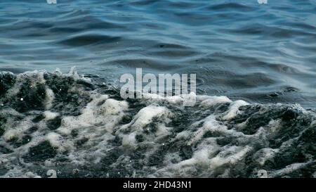 Water Splash from Wake of a Boat. White foam and Bubbles on Crest of Wave in the Ocean. Clear Blue Waters with Waves Stock Photo