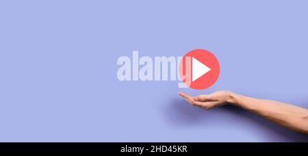 Businessman pressing, hold play button sign to start or initiate projects.Video Play Presentation. Idea for business, technology.media player button. Stock Photo