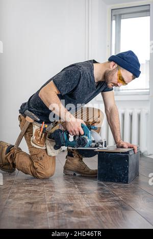 Circular Saw, carpenter using a circular saw for wood. Stock Photo