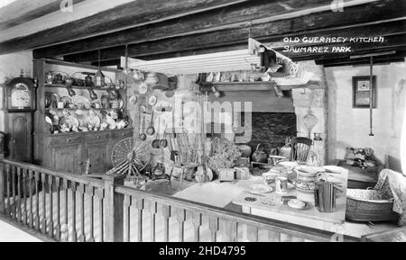 Vintage postcard entitled “Old Guernsey Kitchen, Saumarez Park”. Depicting a reproduction of an old Guernsey kitchen, a display at Guernsey's Folk & Costume Museum at Saumarez Park on the island of Guernsey, Channel Islands. Stock Photo