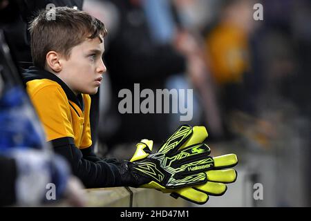 A young Wolverhampton Wanderers fan is seen wearing large goalkeepers gloves - Brighton & Hove Albion v Wolverhampton Wanderers, Premier League, Amex Stadium, Brighton, UK - 15th December 2021  Editorial Use Only - DataCo restrictions apply Stock Photo