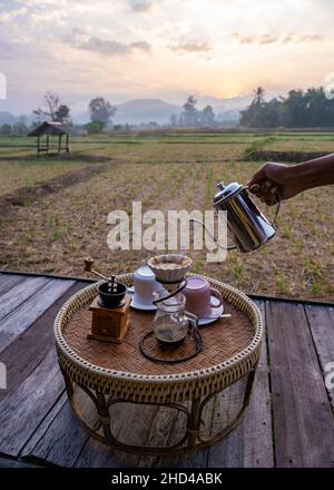 Nan Thailand, drip coffee with a look over the rice fields paddies in the morning during sunrise, coffee in the morning in Nan Thailand Stock Photo
