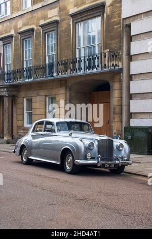 Cambridge, UK - September 18th 2021: Silver Bentley saloon parked on the roadside next to a brick townhouse. In central Cambridge. High quality photo Stock Photo