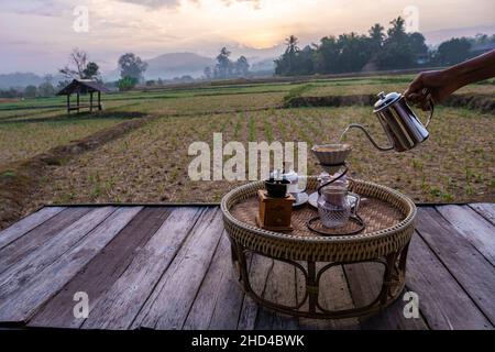 Nan Thailand, drip coffee with a look over the rice fields paddies in the morning during sunrise, coffee in the morning in Nan Thailand Stock Photo