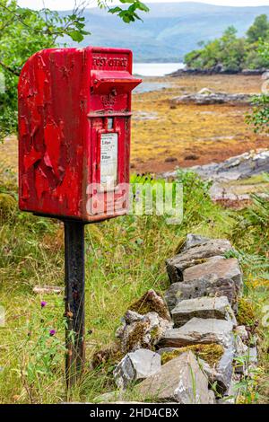 A neglected phone and post box in the highlands of Scotland, in dire need of a repaint. Stock Photo