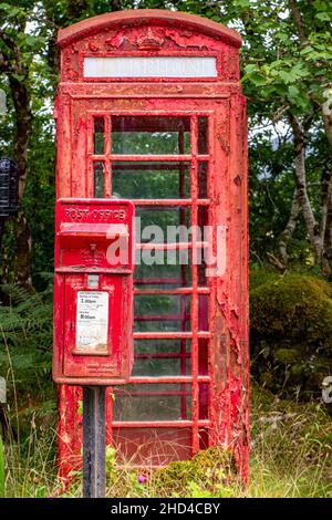 A neglected phone and post box in the highlands of Scotland, in dire need of a repaint. Stock Photo