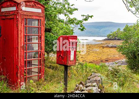 A neglected phone and post box in the highlands of Scotland, in dire need of a repaint. Stock Photo