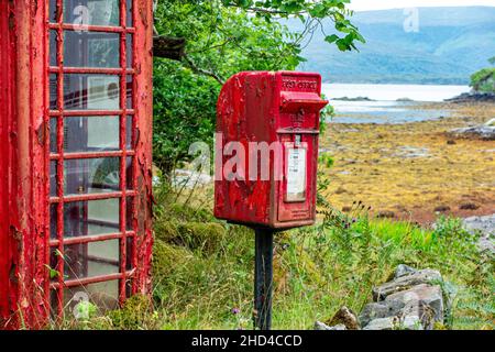 A neglected phone and post box in the highlands of Scotland, in dire need of a repaint. Stock Photo