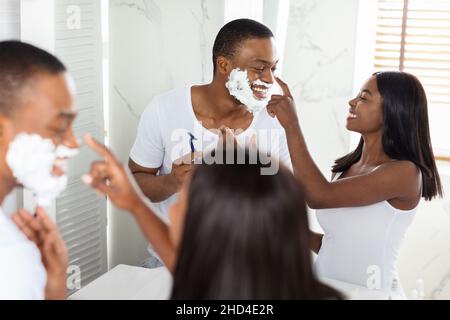 Happy Black Couple Having Fun While Getting Ready Together In Bathroom, Stock Photo