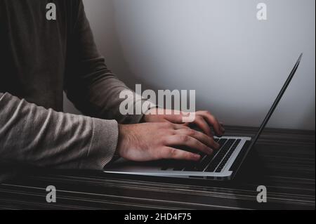 Businessman working on laptop for new project. laptop on the wooden table. Blurred background, horizontal mockup. Stock Photo