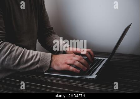 Businessman working on laptop for new project. laptop on the wooden table. Blurred background, horizontal mockup. Stock Photo