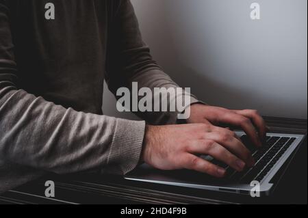 Businessman working on laptop for new project. laptop on the wooden table. Blurred background, horizontal mockup. Stock Photo