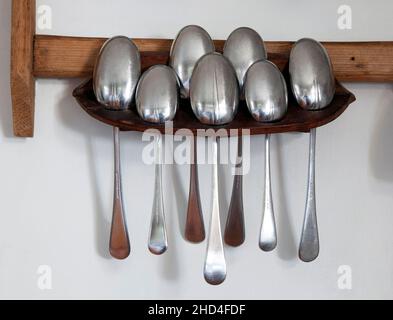 Antique spoon rack in country kitchen Stock Photo