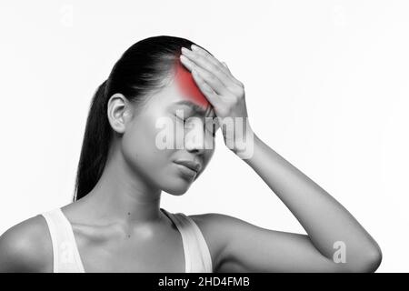 Sick asian woman having coronavirus, touching her forehead Stock Photo