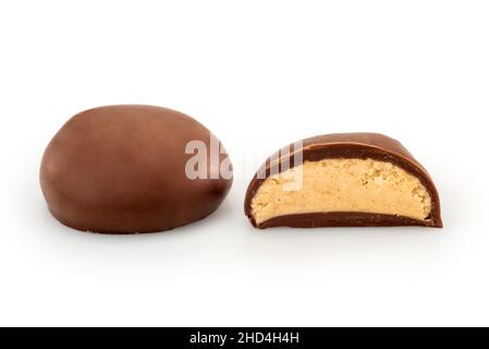 Milk chocolate filled with milk cream and almonds, one whole with one cut in half, isolated on white Stock Photo