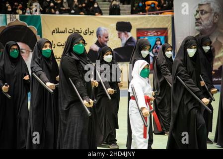 Tehran, Iran. 01st Jan, 2022. A group of women holds their batons in a show during the gathering of Qasem Soleimani's supporters in Tehran, Iran . the Iranian former Islamic Revolutionary Guard Corps (IRGC) Quds Force General Qasem Soleimani was killed in an American drone attack at Baghdad airport. (Photo by Sobhan Farajvan/Pacific Press/Sipa USA) Credit: Sipa USA/Alamy Live News Stock Photo