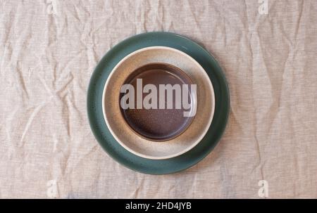 Colored circle shaped ceramic plate on isolated background, food mockup Stock Photo