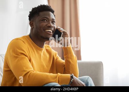 Handsome african american young man having phone conversation with girlfriend Stock Photo