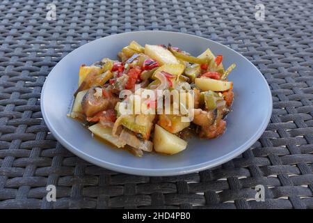 Mixed vegetables oven roasted potatoes zucchini aubergine peppers and onions. Mpriami vegetarian greek food mediterranean cuisine. Stock Photo