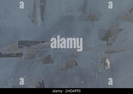 Weathered metal surface with peeled adhesive tape stains. Abstract grunge background. Stock Photo