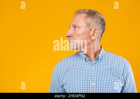 Serious mature man posing looking aside at studio Stock Photo