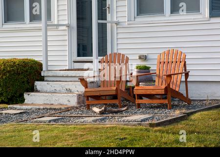 Empty wooden lounge chairs in front of the house Stock Photo