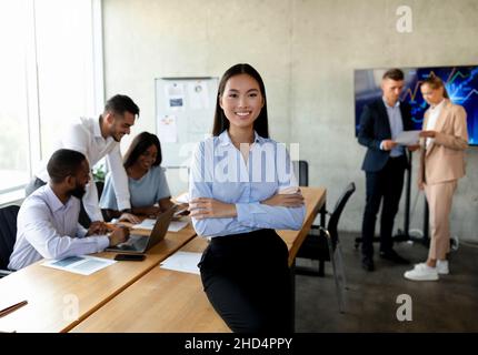 Beautiful asian businesswoman standing in office, posing during corporate meeting in boardroom Stock Photo