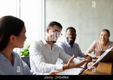 Group Of Multiethnic Coworkers Discussing New Project During Corporate Meeting In Office Stock Photo