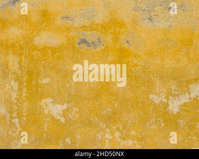 Old dirty yellow textured wall background Stock Photo
