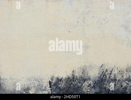 Old textured white painted wall background with black stains Stock Photo