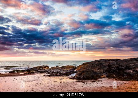 Sunset over the beach at Tresaith in Ceredigion in Wales. Stock Photo