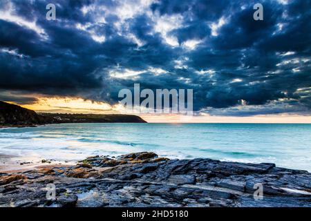 Sunset over the beach at Tresaith in Ceredigion looking towards Aberporth. Stock Photo