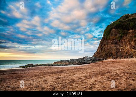 Sunset over the beach at Tresaith in Ceredigion in Wales. Stock Photo