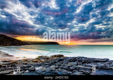 Sunset over the beach at Tresaith in Ceredigion looking towards Aberporth. Stock Photo