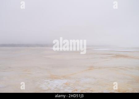 Abstract misty serene winter scene over frozen lake. Blurred background. Defocused image Stock Photo