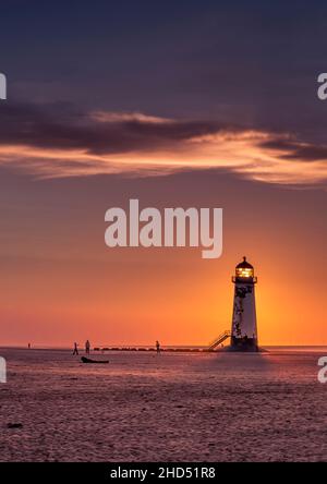 Talacre beach and the Point of Ayr Lighthouse at sunset. Stock Photo