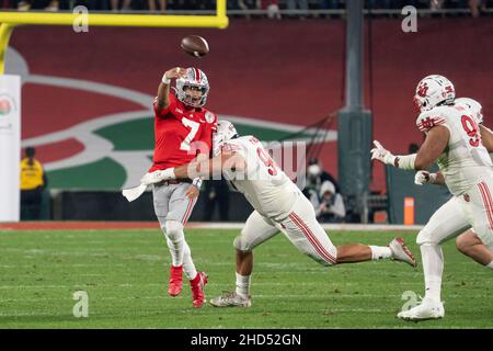 Ohio State Buckeyes quarterback C.J. Stroud (7) is hit by Utah Utes defensive tackle Devin Kaufusi (90) as he throws a pass during the 108th Rose Bowl Stock Photo