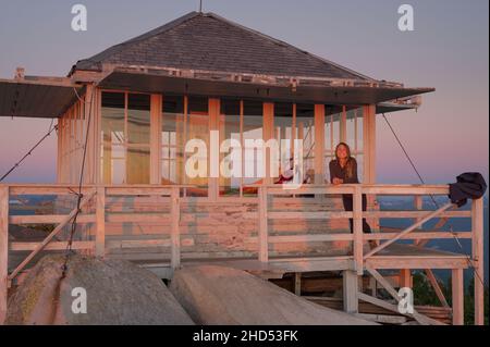 Girl smiling at camera on deck of Mount Pilchuck fire lookout Stock Photo