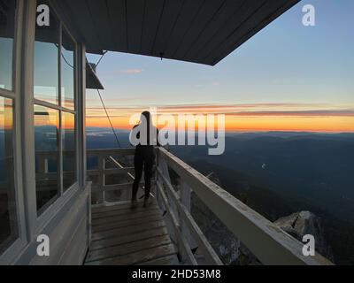 Female standing on the deck of mount pilchuck fire lookout Stock Photo