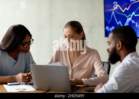 Project Discussion. Multiethnic Colleagues Working Together With Documents In Office Stock Photo